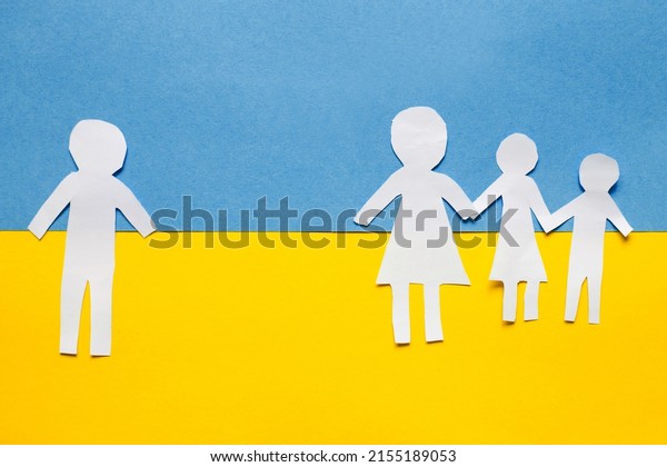 paper cut divided family on the background\
of the ukrainian flag. stop war\
concept.