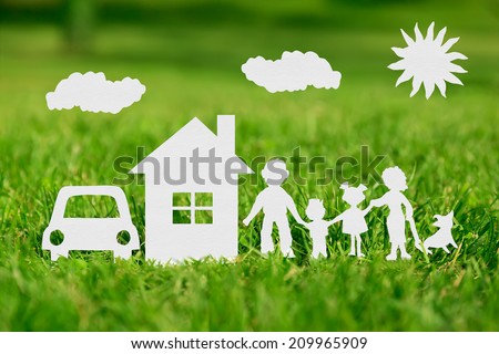 Paper cut of family with house and car on green grass