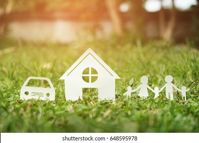 Paper cut of family on green grass, Concepts saving money for House and car, Vintage tone.
