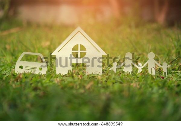 Paper cut of family on green grass,\
Concepts saving money for House and car, Vintage\
tone.