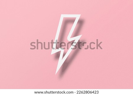 Paper cut lightning shape, lightning with light and shadow. Placed on a pink paper background.