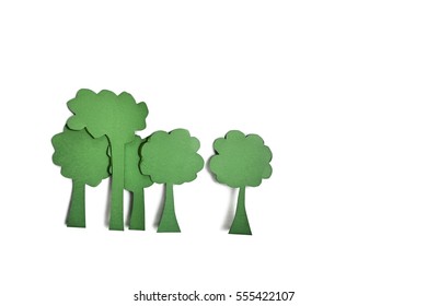 Paper cut outs of green trees over white background