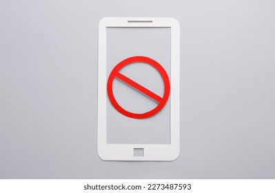 Paper cut Smartphone with red prohibition sign on yellow background. Ban - Shutterstock ID 2273487593