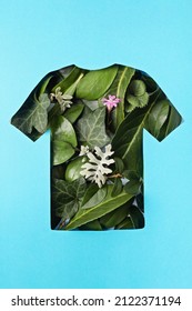 Paper cut t-shirt shape filled with green leaves. Organic cotton production, sustainable, ethical shopping, slow, circular fashion concept