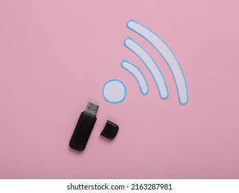 Paper Cut Waves Wi-fi Icon And Usb Flash Drive On Pink Background. Top View