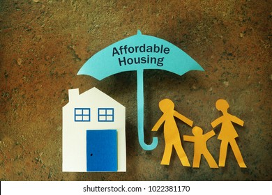 Paper Cutout Family With House Under An Affordable Housing Umbrella                               