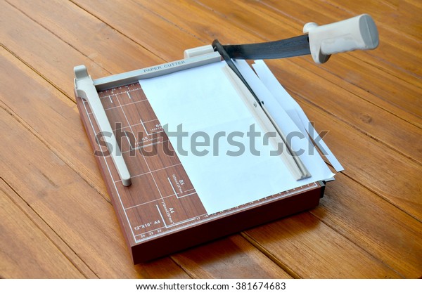 Paper cutter cutting paper\
A4