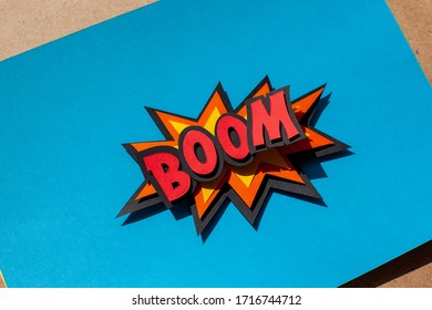 Paper cutting comic speech bubble on blue background. Boom. Bomb. 