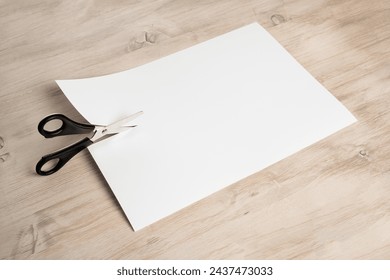 Paper cutting with scissors. A layout of a blank sheet of paper for assignments, a presentation of the design of paper crafts, a template.