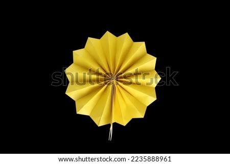 Paper decorations for parties, new year, bachelorette, birthdays, or carnivals. Bright, round, and yellow-colored rosettes