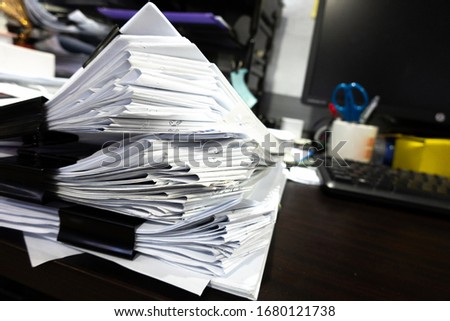 Paper document stacking on the table.