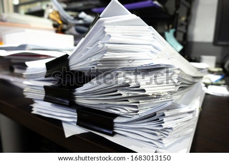 Paper document stacking on the table.