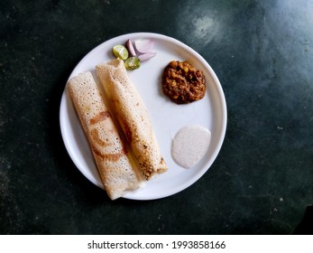 Paper Dosa Served With Coconut Chutney And Onion, Lemon Slices (south Indian Dish) 