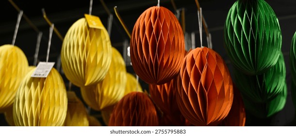 Paper Easter eggs hanging in a decor store. Origami egg.