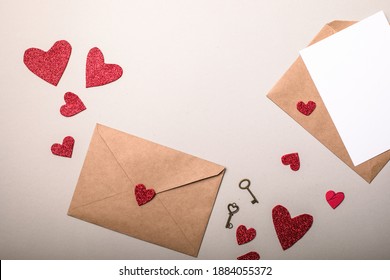 Paper envelope with Valentines hearts on gray background. Flat lay, top view. Romantic love letter for Valentine's day concept.