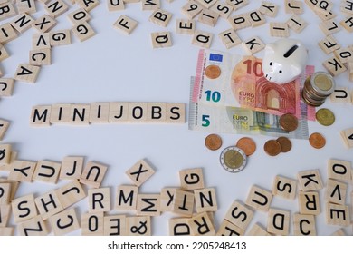paper euro banknotes, piggy bank, bills on table among euro coins, word Mini job with wood blocks, part-time with low wage concept, marginal employment, help for pension fund, health insurance