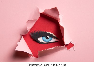 The Paper Eye Spy On Through The Torn Paper.