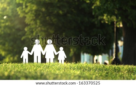 paper family on green grass
