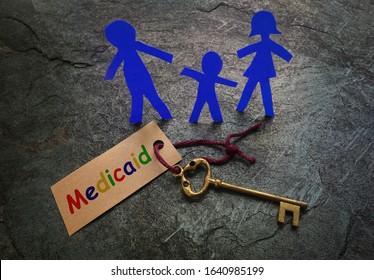 Paper Family Of Three With Gold Key And Colorful Medicaid Tag               