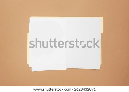 Paper file folder with blank sheets on light brown background, top view