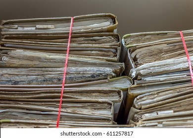 Paper files in a folder is a old documents or old letter it's a age-old and ancient archiving by stacking up in a documents paper shelf messy order