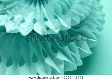 Paper flowers on mint background, closeup