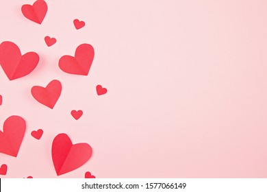 Paper Hearts Over The Pink Pastel Background. Abstract Background With Paper Cut Shapes. Sainte Valentine, Mother's Day, Birthday Greeting Cards, Invitation, Celebration Concept