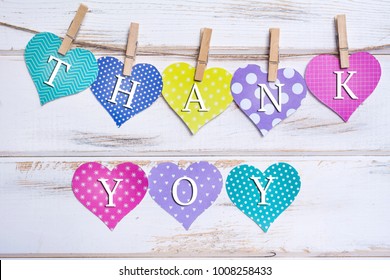 Paper Hearts with Thank you text on a White Wooden Planks Background
