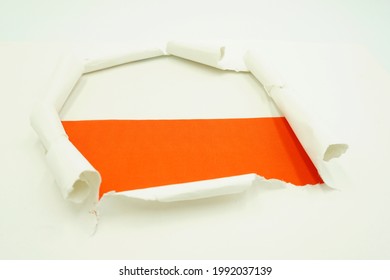 Paper Hole With Polish Flag Inside On A White Background. Flag Background, Concept Wallpaper.