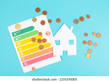 Paper house and Euro coins, power consumption grafic, increasing heating costs, green technology, inflation, social and financial issue