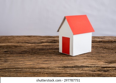 paper house symbolizing on wooden table. love family concept