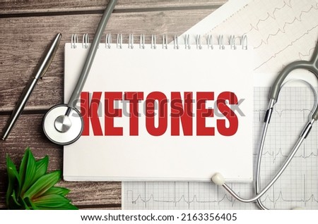 Paper with ketones on a table with stethoscope on wooden background
