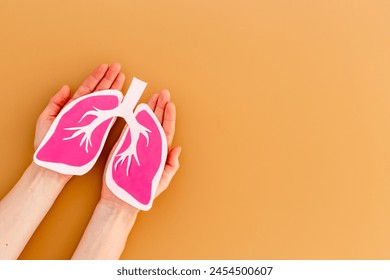 Paper lungs organ model in human hands, top view. Medical concept. - Powered by Shutterstock