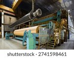 Paper machine operating in a large paper mill during daytime hours