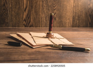 Paper mail and stamp on wooden table - Shutterstock ID 2258920505