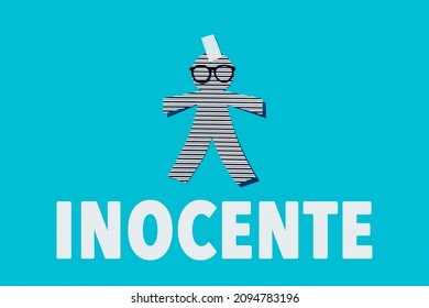 paper man doll with eyeglasses on a blue background, and the word innocent written in spanish, as a prank for the innocents day, a feast held in some countries equivalent to april fools day