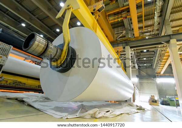 paper mill: production of paper rolls\
for the printing industry - paper rolls in a factory\
