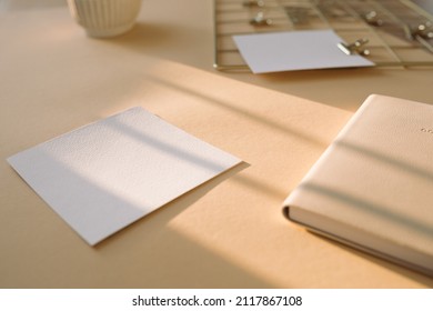 Paper Mock Up, Daily Planner On Beige Office Desk With Beautiful Sunlight. Minimal Aesthetic Business Brand, Blog, Social Media Template Background.