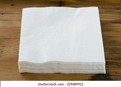 paper napkin on brown wooden background