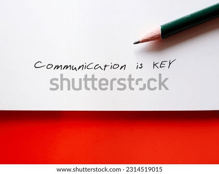 paper note on orange background with handwritten text COMMUNICATION IS KEY, means communication is key to build relationship and achieve personal professional goals - essential for successful business