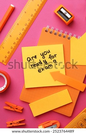 Paper note with question Are You Ready For Exam and stationery on pink background, flat lay