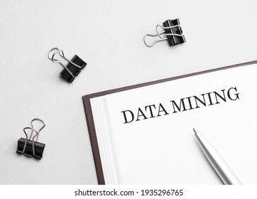 Paper Note With Text DATA MINING, Pen And Office Tools, White Background. Business Concept