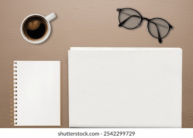 Paper and notebook flat lay. Flat lay top view blank paper and notebook with coffee aesthetic advertisement business branding mockup photo. Flat lay paper mockup showcase for business. - Powered by Shutterstock