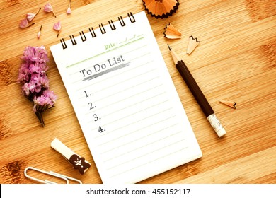 paper notepad book with pencil  on wooden table for to do check list concept , overhead shot or Top view