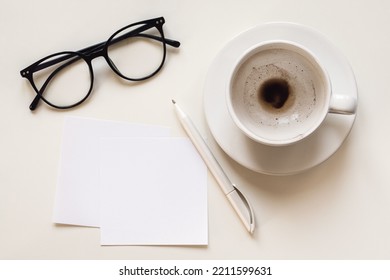 Paper Notes, Blank Space, Empty Coffee Cup, Eyeglasses And Pen On White Desk, Overhead Flat Lay Mockup