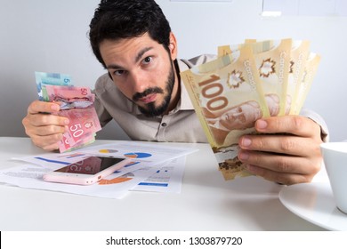 Paper Notes From Canada. Dollar. Canadian Cash. Young Adult Holding Many Bills On Table.