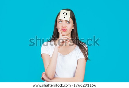 Paper notes with question marks. Confused female thinking with question mark on sticky note on forehead. Thinking woman with question mark. Doubtful girl asking questions to himself.