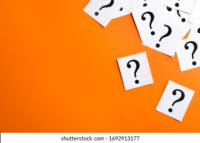 Paper Notes With Question Marks On Orange Background, Flat Lay. Space For Text