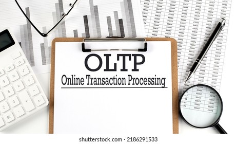 Paper with OLTP - Online Transaction Processing table on charts, business concept