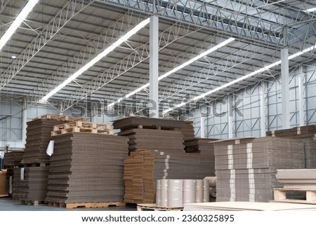 Paper packaging manufacturing. Pile of paper packaging in warehouse storage. Stacking of paper cardboard in warehouse
